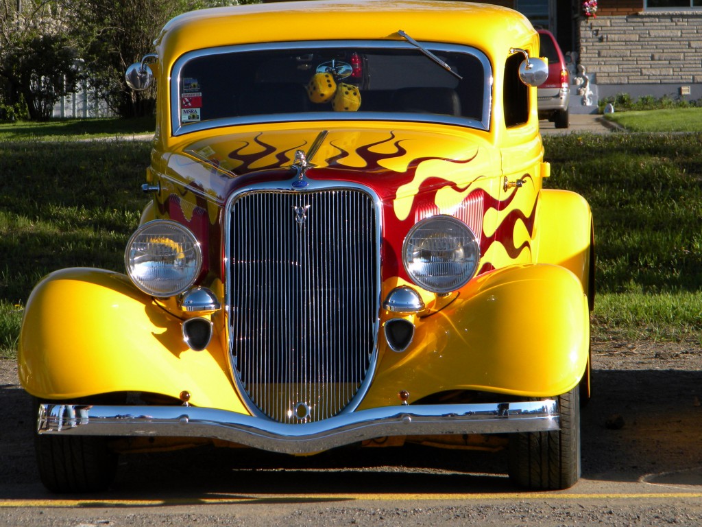 Yellow hot rod antique car with flames